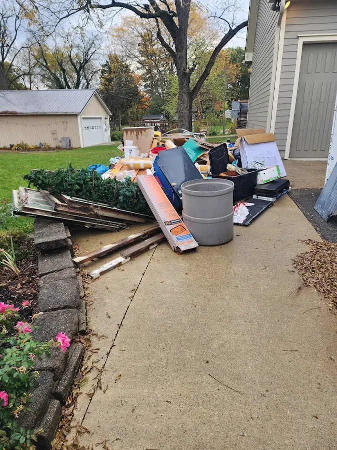 Dumpster being loaded with debris for Roofing Dumpster Rental in Carthage